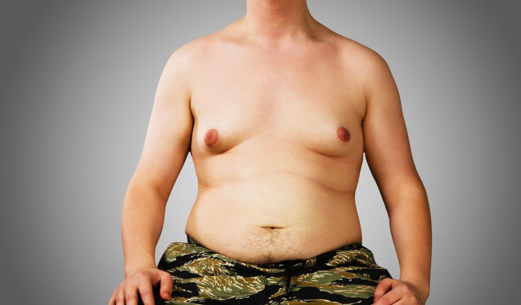 Body of young man with excess weight, keep belly fat, on a gray background.